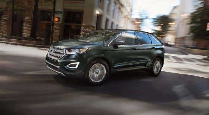A black 2016 Ford Edge is shown on a city street after leaving a Murfreesboro used Ford dealership.