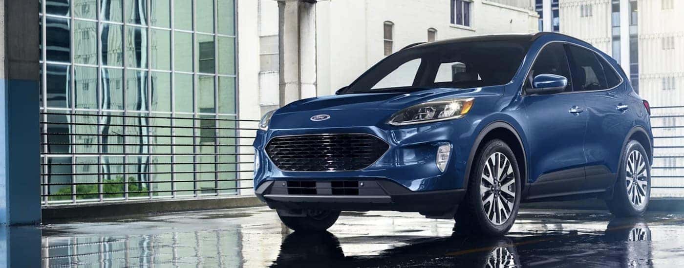 A blue 2022 Ford Escape Hybrid is shown from the front parked in a gallery.