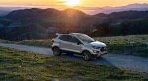 A silver 2022 Ford EcoSport SES is shown on a mountain trail at sunset.