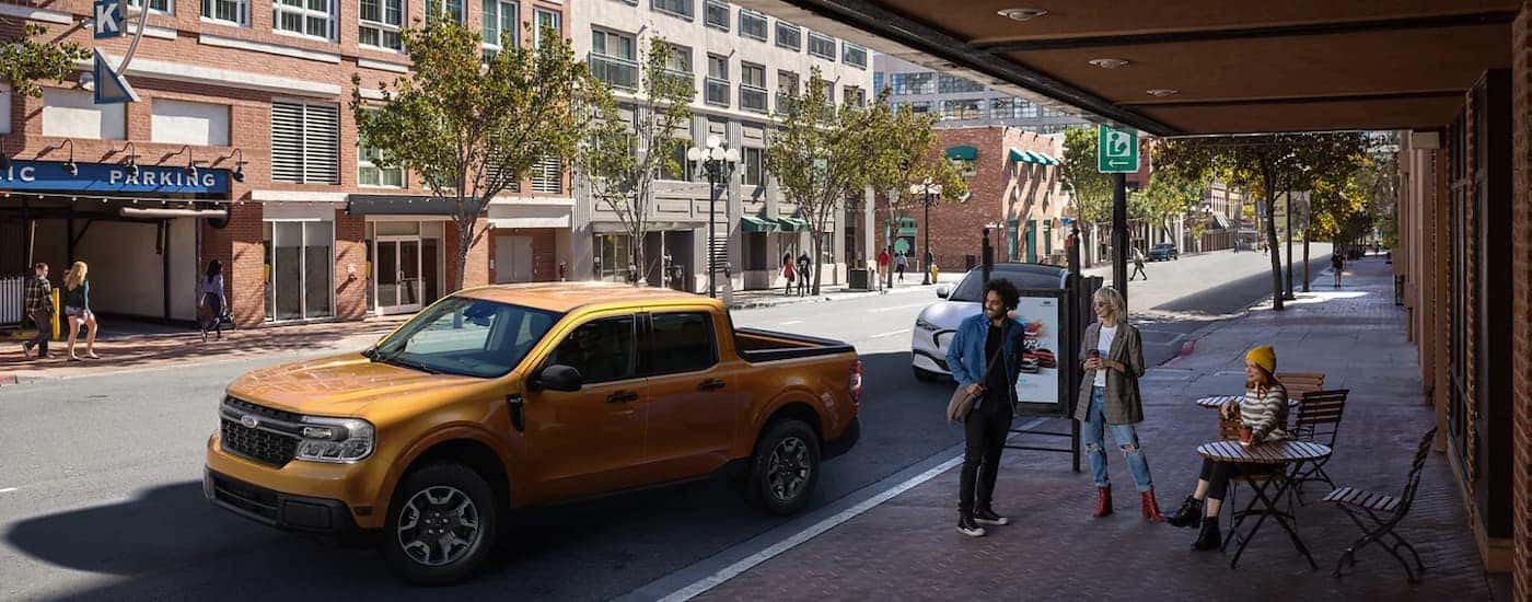 A gold 2022 Ford Maverick is shown parked on the side of a city street.