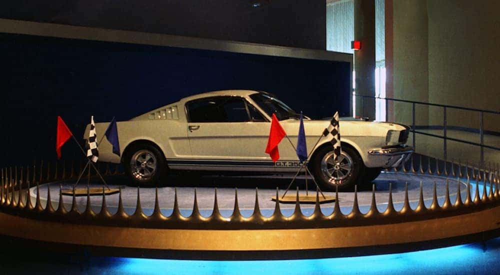 A white 1964 Ford Mustang Shelby GT350 is shown on display at the World's Fair.