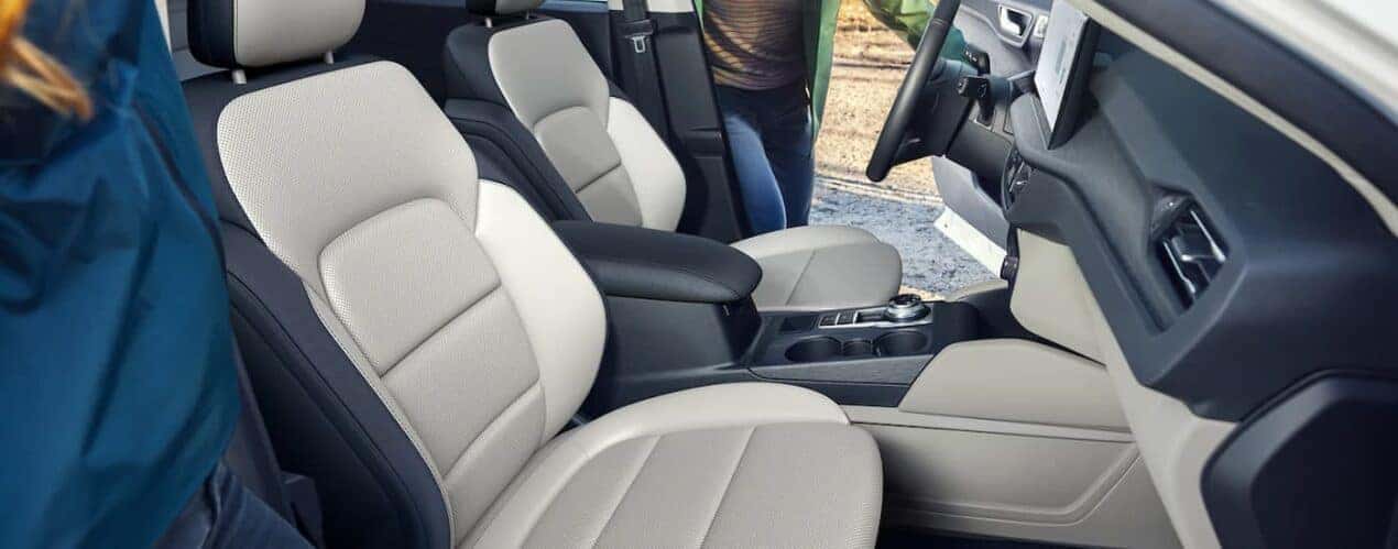 The black and grey interior of a 2023 Ford Escape shows the front seating and center console.