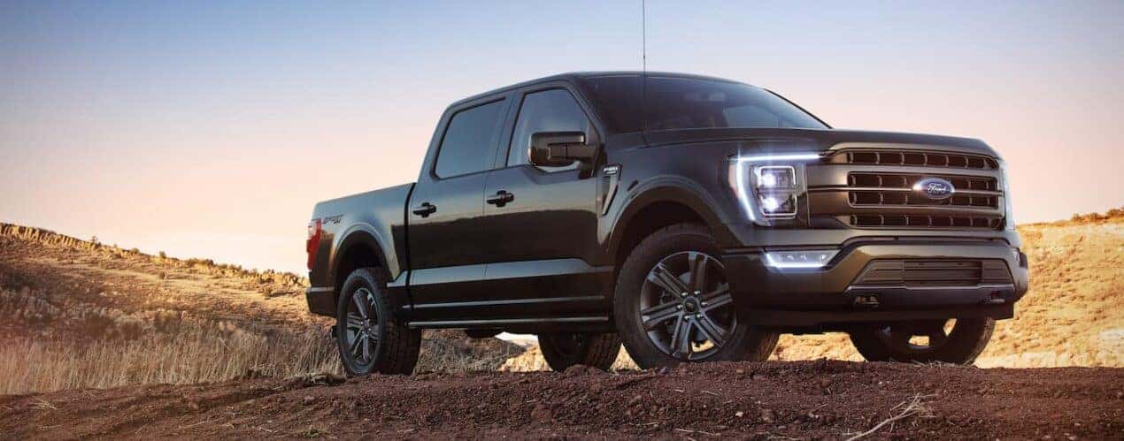 A black 2023 Ford F-150 is shown from the front at an angle.