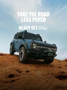 Ford Bronco driving over a hill