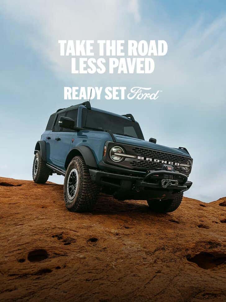 Ford Bronco driving over a hill