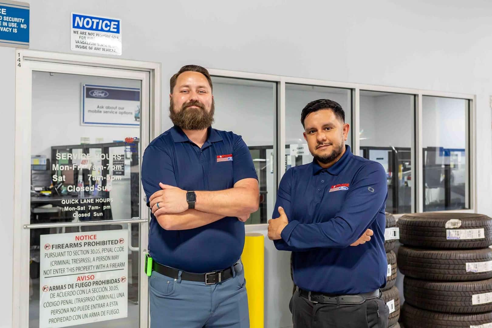 two employees standing in front of service advisors
