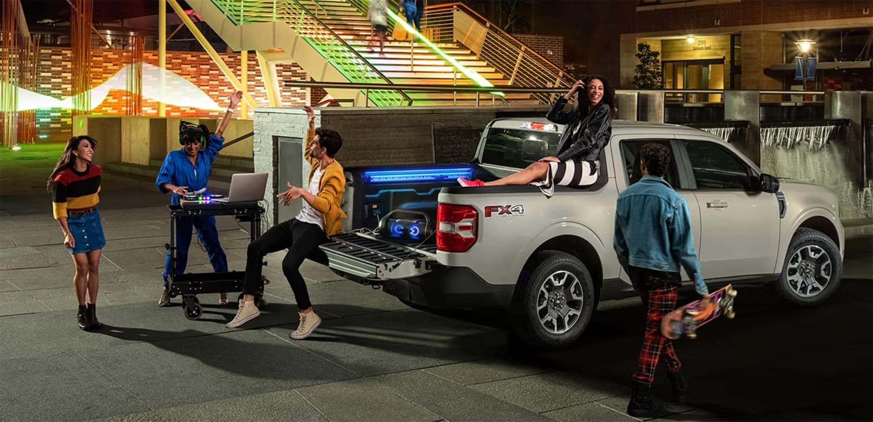 tailgate party surrounding the bed of a new Ford Maverick