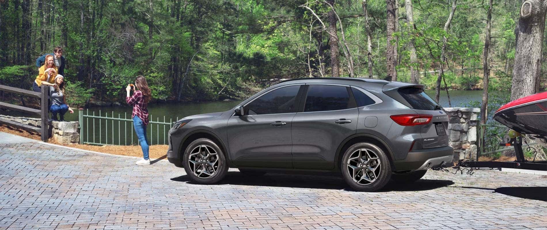 New Ford Escape parked with a family nearby