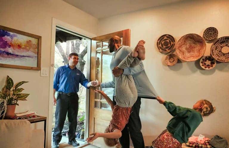 people in entry way of house