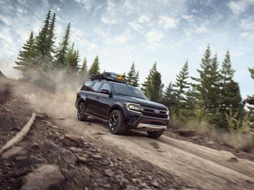 2024 Ford Expedition driving down a dirt path on the side of a mountain