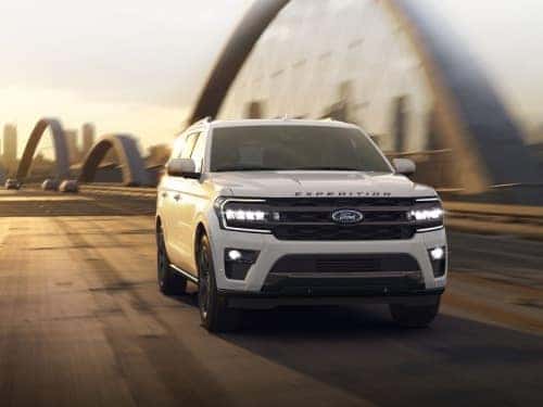 2024 Ford Expedition driving across a bridge outside a city