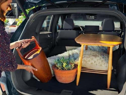 2025 Ford Escape view of woman loading garden supplies into cargo area