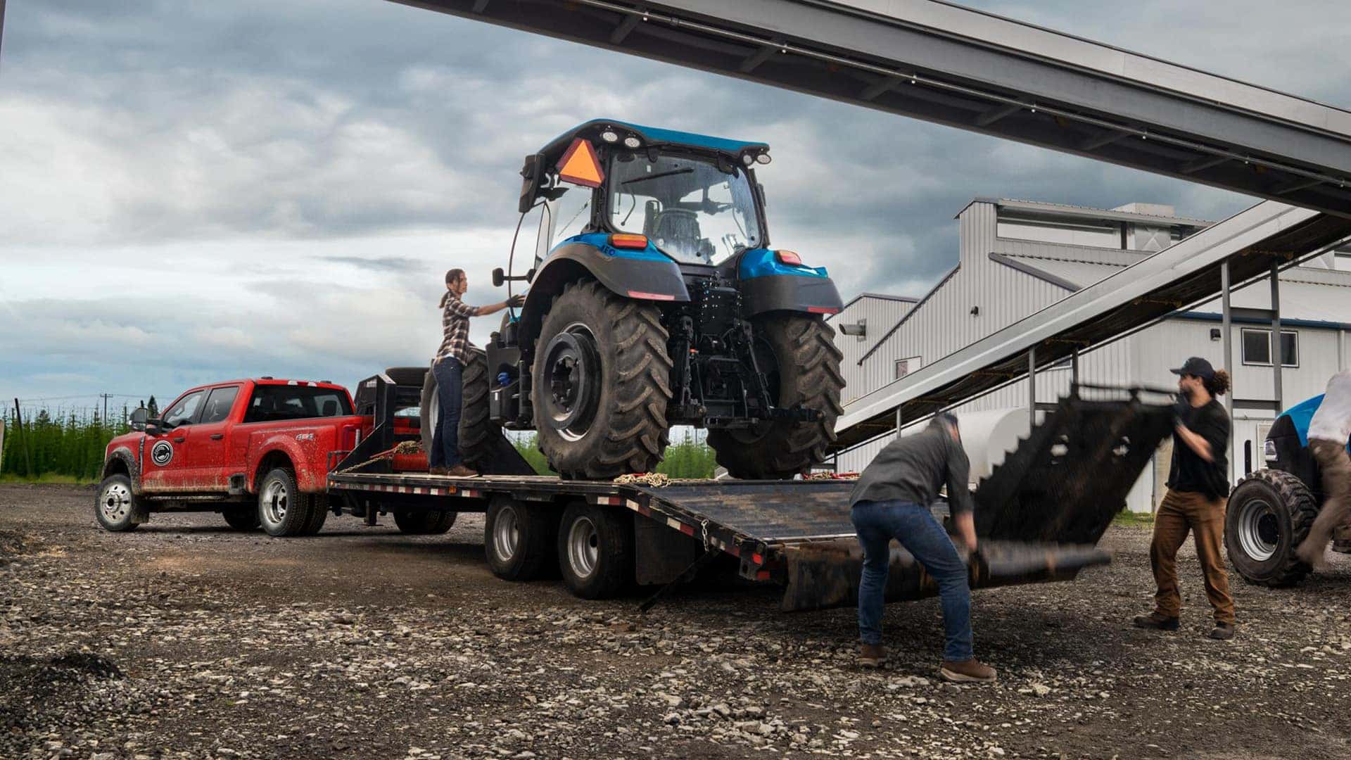2026 Ford Super Duty Hauling a Tractor on Farm