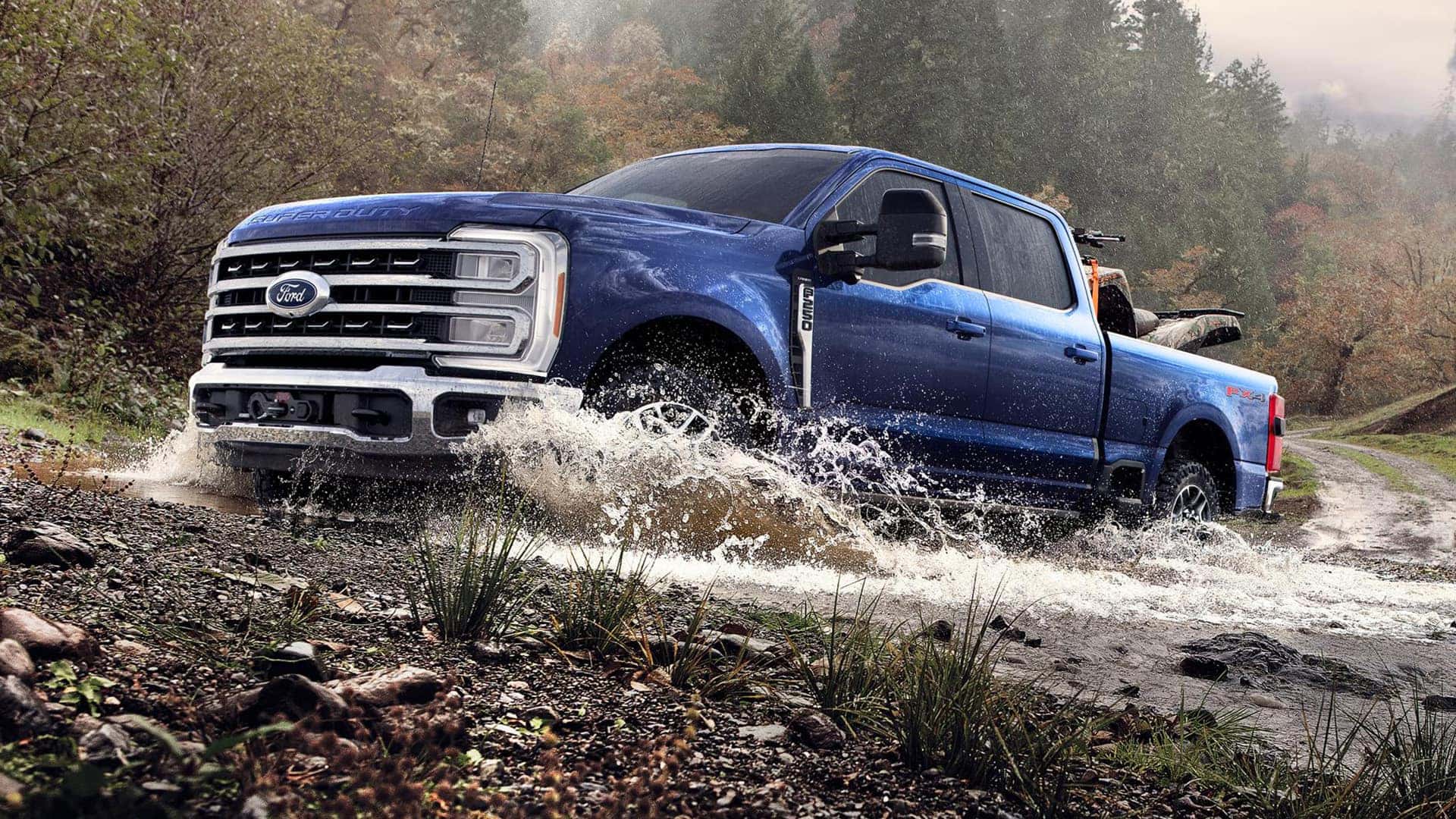 Blue 2026 Ford Super Duty Driving Through Mud