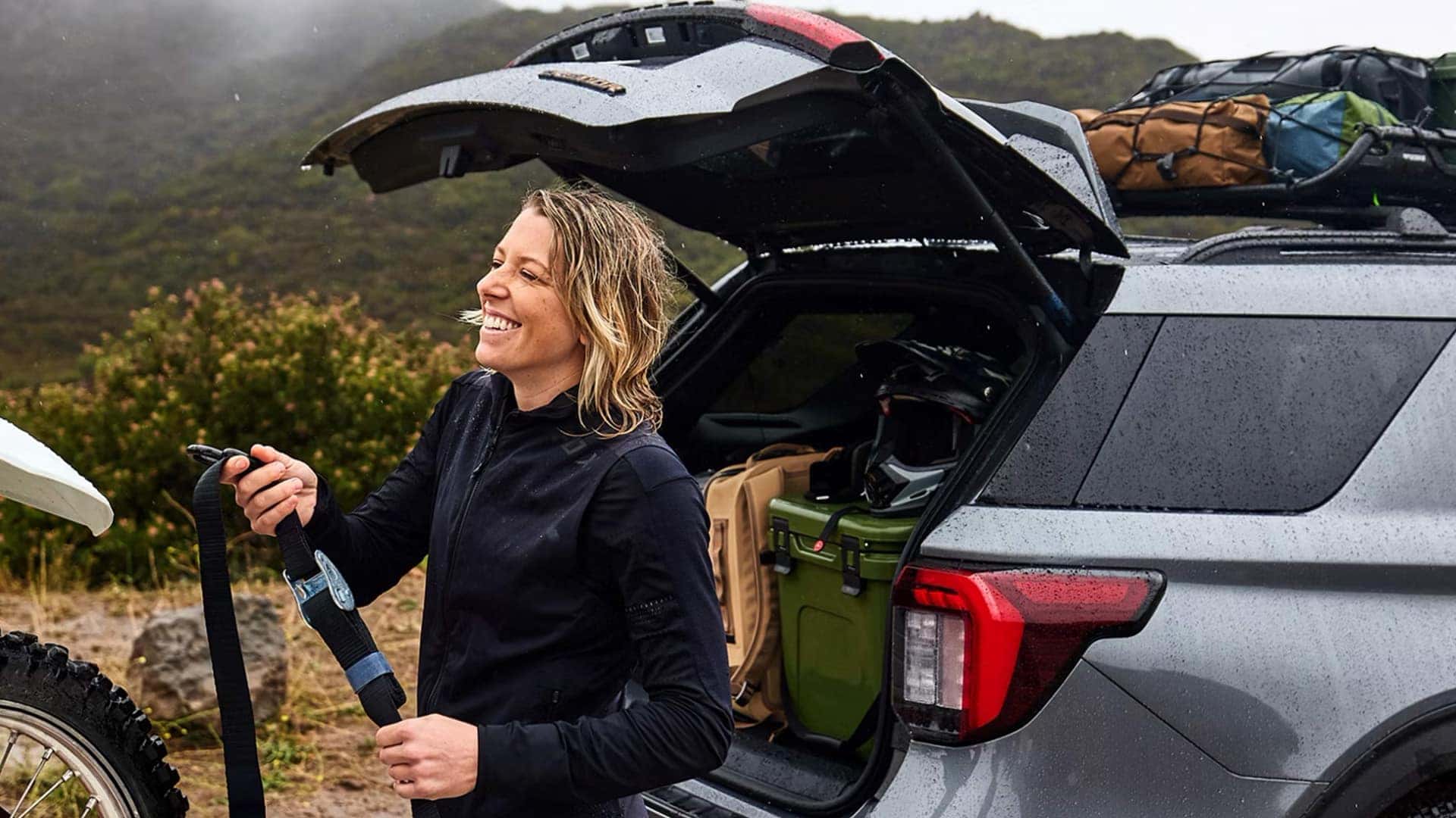 Laughing Woman with Outdoor Gear Next to 2026 Ford Explorer