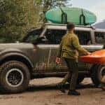 People Carring Kayak Next to 2026 Ford Bronco