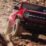 Red 2026 Ford Bronco Offroading on Rocks