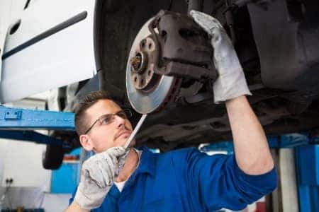 Man repairs brakes and rotors