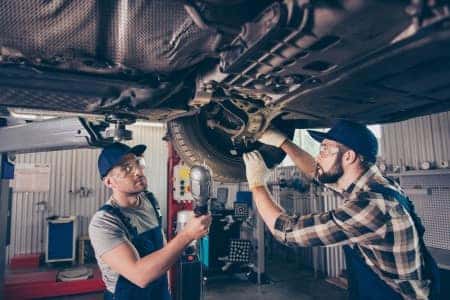 Two men repair brakes