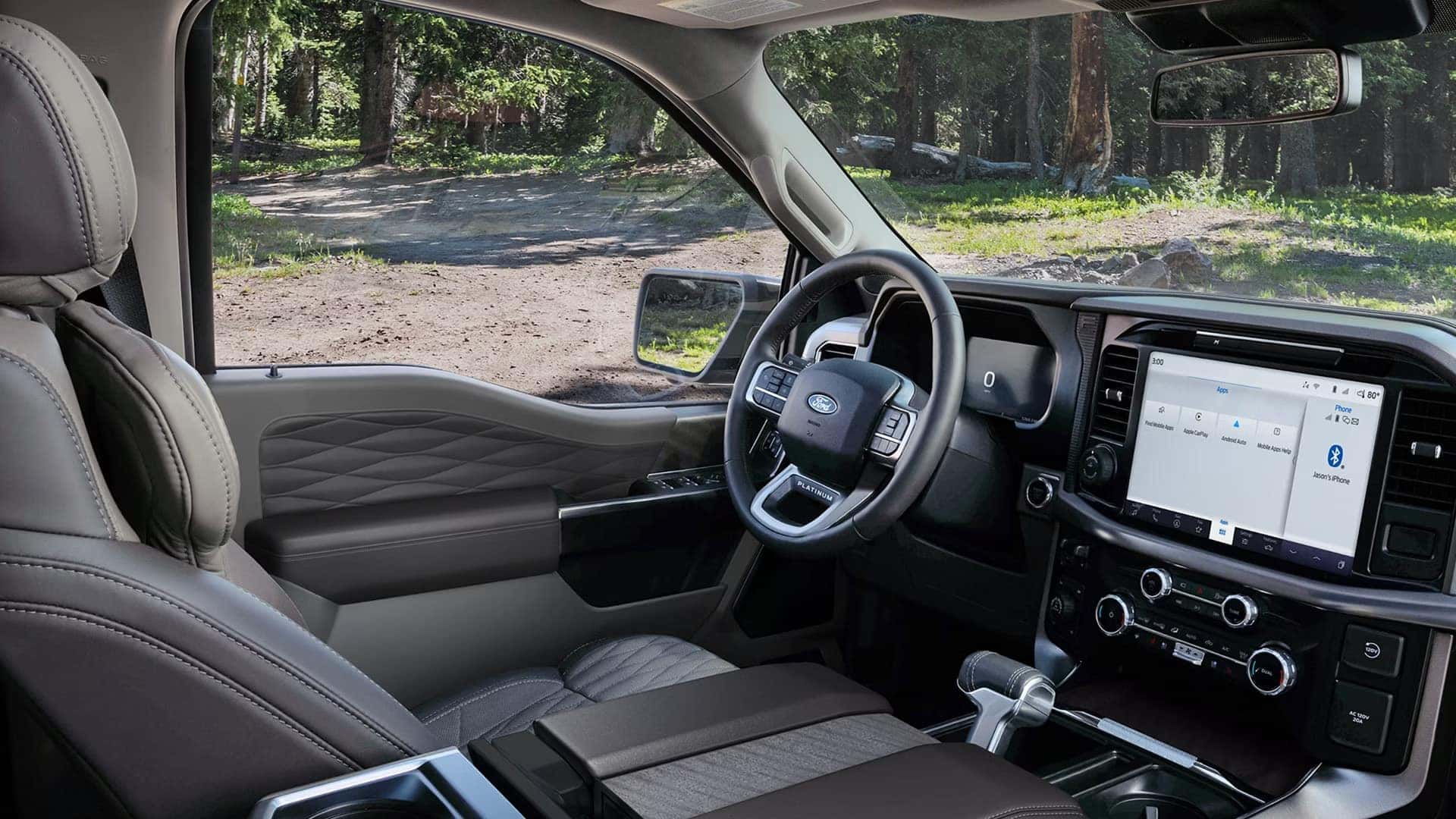 Driver view of the 2026 Ford F-150 interior with digital instrument cluster, large center touchscreen, and steering wheel controls.