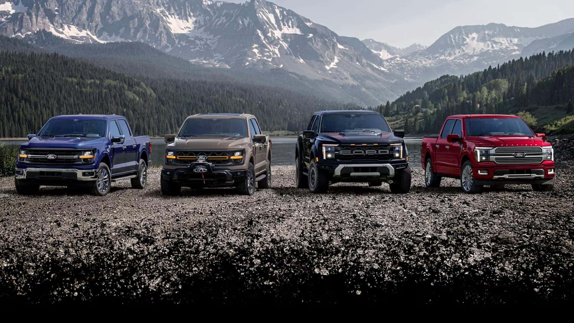 Lineup of 2026 Ford F-150 trucks in multiple trims and colors parked outdoors, showcasing trim level variety and exterior styling differences.