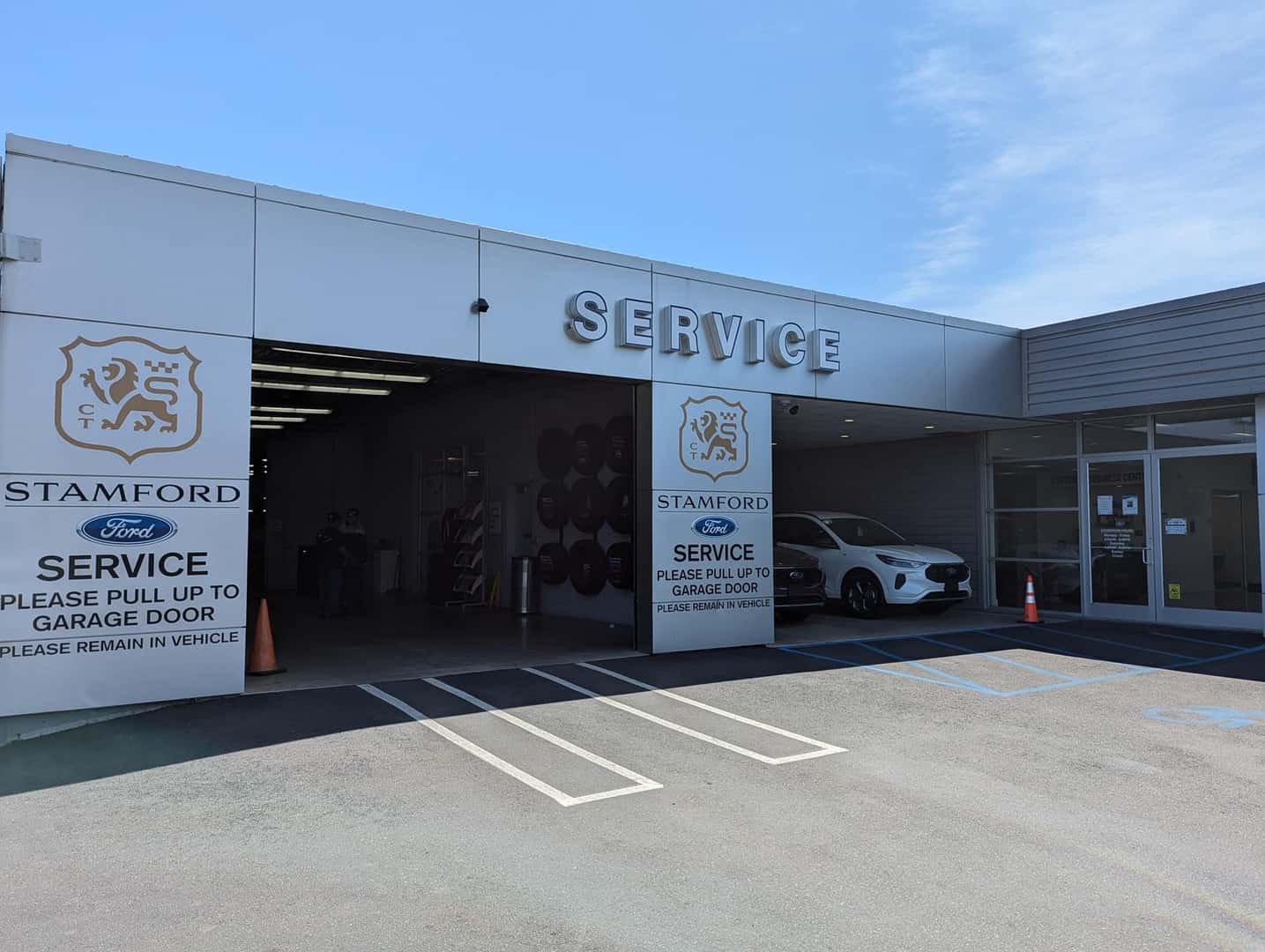 Ford Mechanic passing keys to a customer