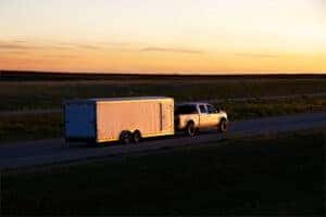 F150 pickup truck towing a trailer on the road