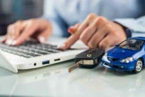 buy a car online and have it delivered, customer using laptop to shop for cars