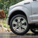 A close up shows the front wheel and tire on a 2016 Ford F-150 Limited.