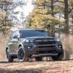 A black 2021 Ford Explorer Timberline is shown in the woods after leaving a Shepherdsville Ford dealer.