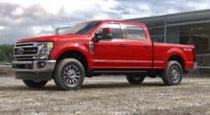 A red 2022 Ford Super Duty -250 is shown from the side after leaving a Louisville Ford Super Duty dealership.